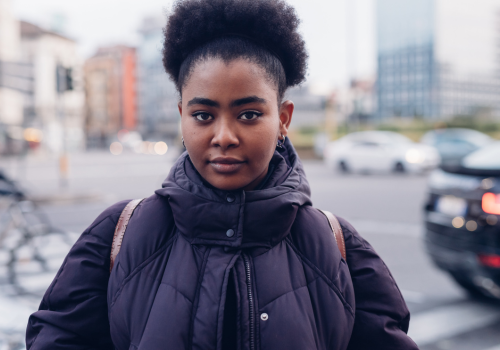 woman in black coat looking directly at camera