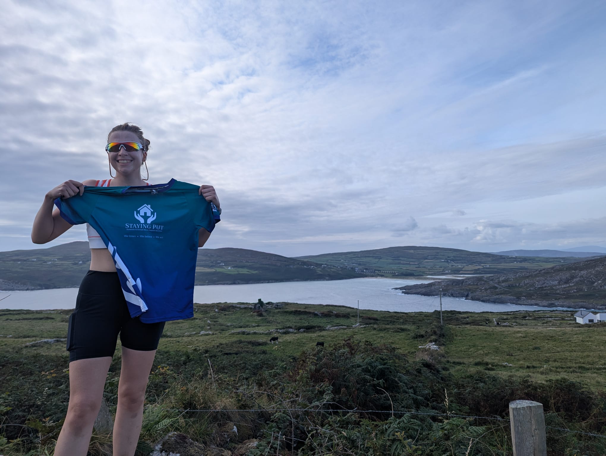 Marathon runner holding Staying Put shirt