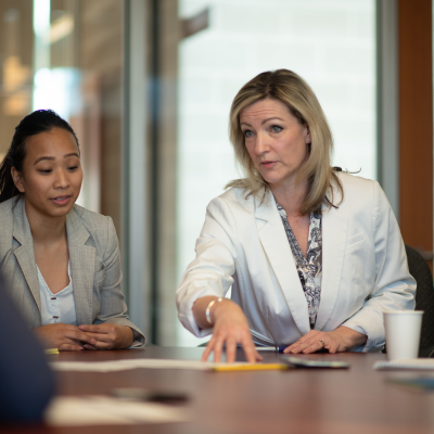 woman sat at desk talking