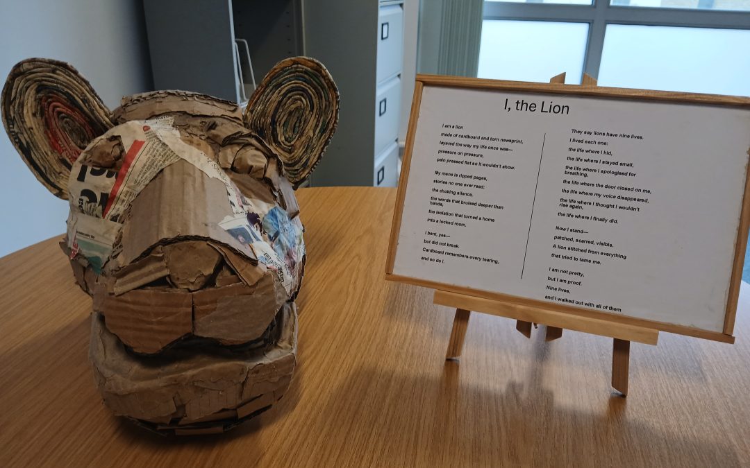 Paper mache Lion with poem next to it